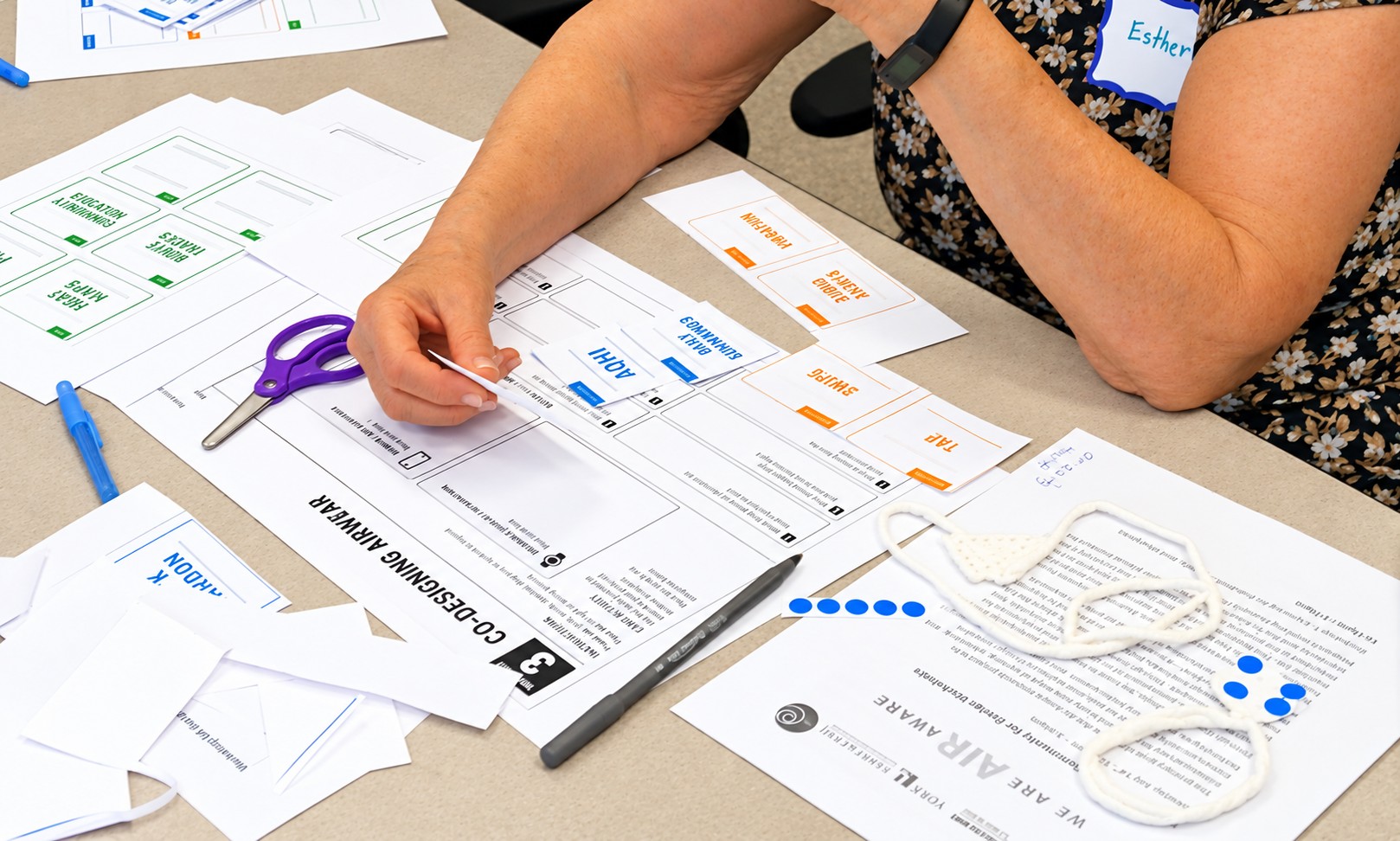 Participant arranging interface and information cards during an AirWear co-design activity
