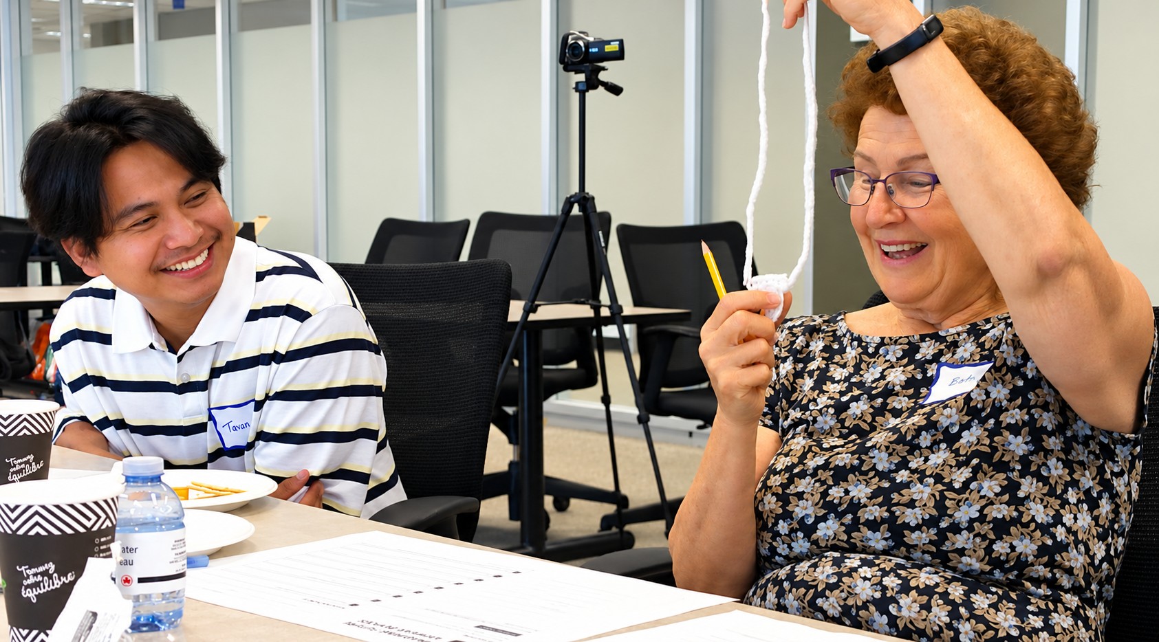 Two workshop participants laughing together while discussing wearable design ideas